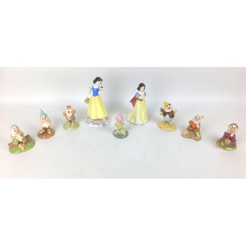 39 - A group of nine  Royal Doulton Disney Snow White and the seven Dwarfs figurines, modelled as Snow Wh... 