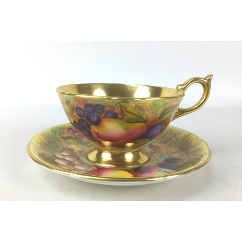 76 - A mid 20th century hand painted Aynsley tea cup and saucer, signed by Doris Jones, in Orchard Gold p... 