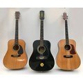 Three acoustic steel string guitars, comprising a 1970s Eko twelve string in black, an Aria SW20 six... 