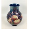 A Moorcroft pottery finch and berry pattern baluster form vase, with impressed marks to base, signed... 