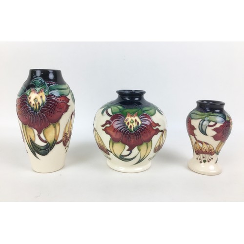 25 - Three Moorcroft pottery Anna Lily pattern vases, all with impressed marks to base, two of ovoid form... 
