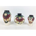 Three Moorcroft pottery Anna Lily pattern vases, all with impressed marks to base, two of ovoid form... 