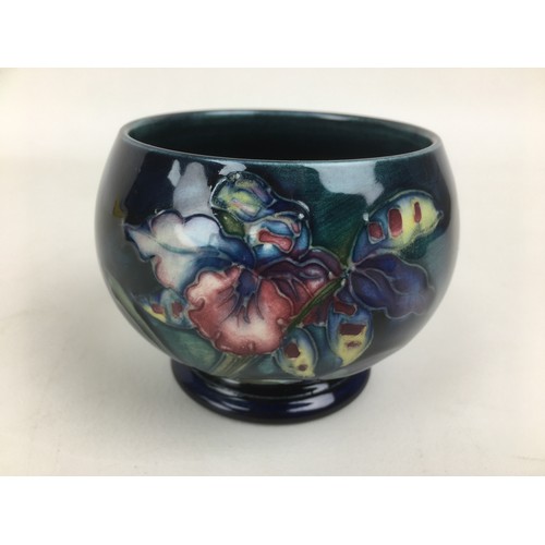 27 - Three pieces of Moorcroft pottery, comprising, two clematis pattern pieces, a bowl,  16 by 7cm high ... 
