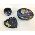 Three pieces of Moorcroft pottery, comprising, two clematis pattern pieces, a bowl,  16 by 7cm high ... 