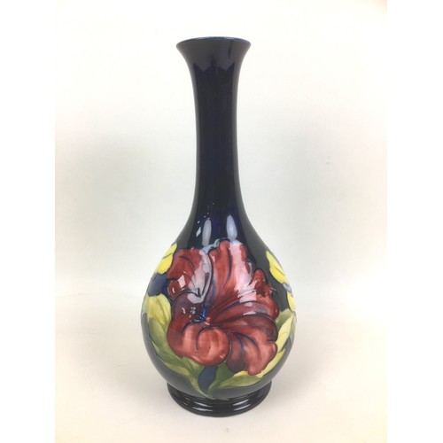 29 - Two pieces of Moorcroft pottery decorated with the hibiscus pattern and with impressed marks to thei... 