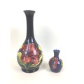 Two pieces of Moorcroft pottery decorated with the hibiscus pattern and with impressed marks to thei... 