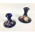 Two mid 20th century and later Moorcroft pottery candlesticks, comprising decorated in the leaf and ... 