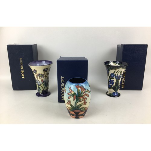 36 - Three Moorcroft pottery vases, comprising two vases of tapering form, one in violet pattern with imp... 