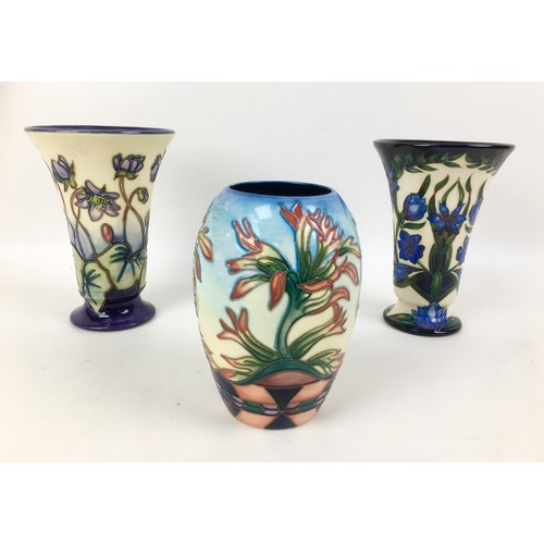 36 - Three Moorcroft pottery vases, comprising two vases of tapering form, one in violet pattern with imp... 