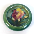 A Moorcroft lipped trinket bowl, tube line and painted, decorated with lillies, impressed Moorcroft ... 