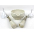 A large porcelain mortar, 23.5 by 28 by 13.5cm high,  with two pestles, largest 28cm long and two po... 