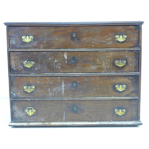 318 - An early 18th century oak chest of four drawers, with brass handles and lock plates, black metal han... 