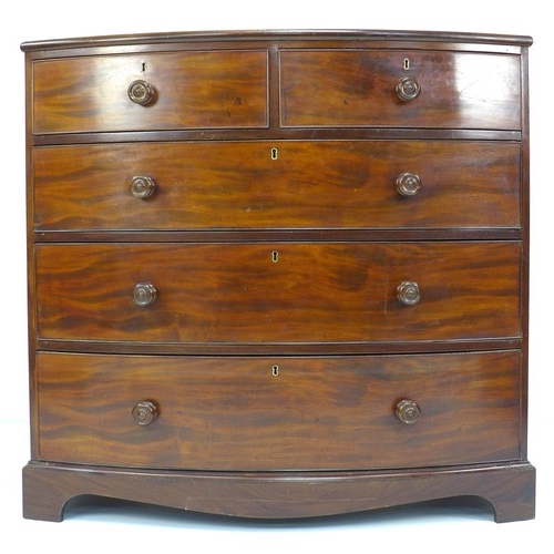 299 - A Regency mahogany bowfront chest of drawers, two short over three long, with cock beading and turne... 