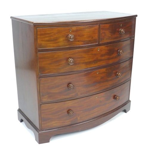 299 - A Regency mahogany bowfront chest of drawers, two short over three long, with cock beading and turne... 