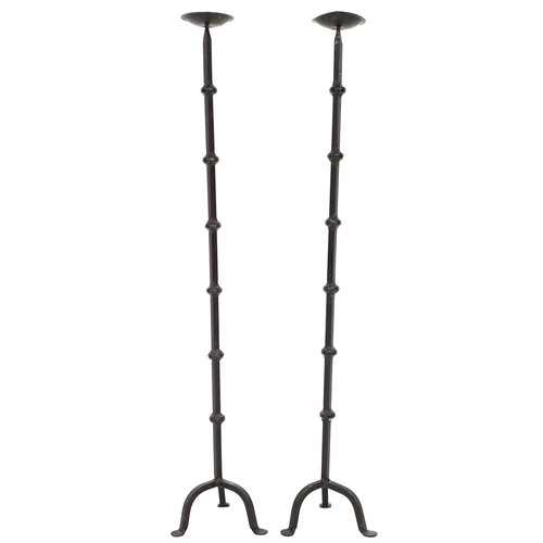 298 - A pair of wrought iron pricket candle stands, each with a circular cupped drip tray on a square sect... 