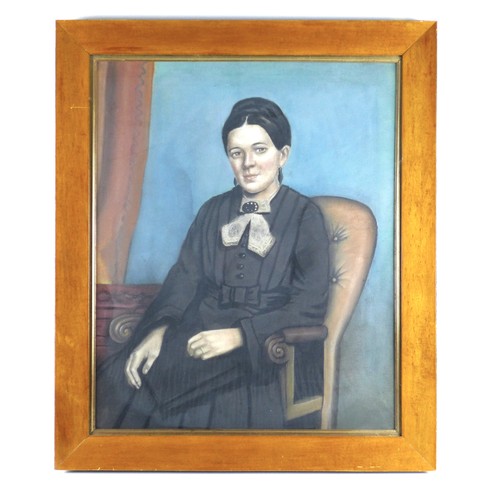 136 - British School (20th century): a half length portrait of a woman seated in a Victorian armchair, wea... 