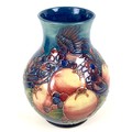 A Moorcroft pottery vase, of baluster form, decorated in Finch and Berry pattern, impressed and pain... 