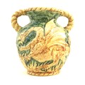 An unusual West German pottery double handled vase, decorated in relief with a dragon on a green gro... 