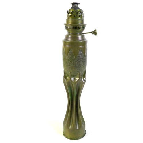 276 - An Art Nouveau/Secessionist trench art oil lamp, of organic, fluted waisted form below planished ovo... 