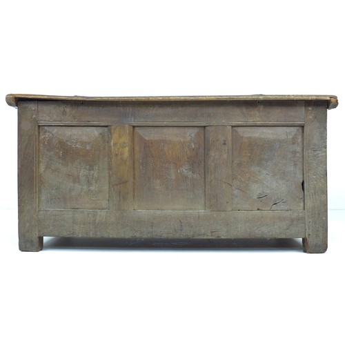 304 - An 18th century oak chest, lift top, candle compartment to one side, loop hinges, three panel front,... 