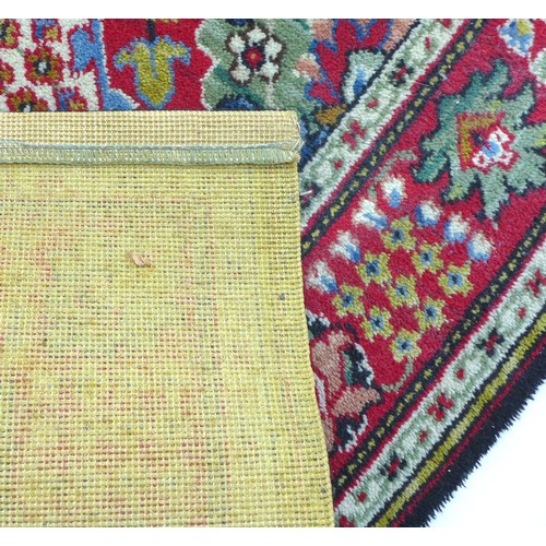 279 - A mid 20th century carpet, ‘Lomond’ brand, number 1204, with red ground and multiple square set patt... 