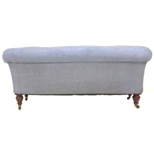 293 - A Victorian Chesterfield two seater settee, upholstered in pale blue fabric, with turned mahogany le... 