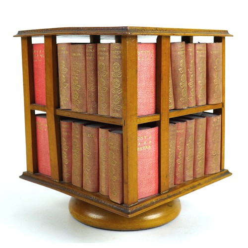 92 - A miniature table top revolving bookcase, containing a set of forty miniature Shakespeare plays, in ... 