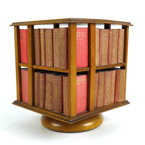 92 - A miniature table top revolving bookcase, containing a set of forty miniature Shakespeare plays, in ... 