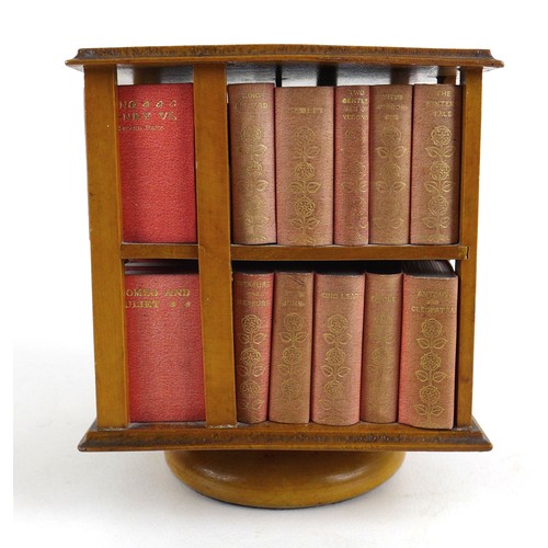 92 - A miniature table top revolving bookcase, containing a set of forty miniature Shakespeare plays, in ... 