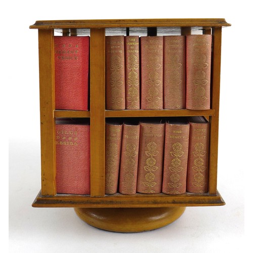 92 - A miniature table top revolving bookcase, containing a set of forty miniature Shakespeare plays, in ... 