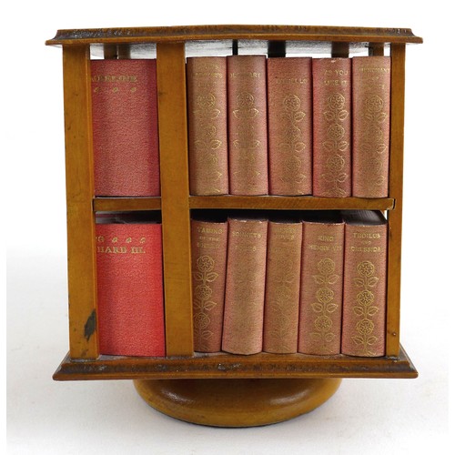 92 - A miniature table top revolving bookcase, containing a set of forty miniature Shakespeare plays, in ... 