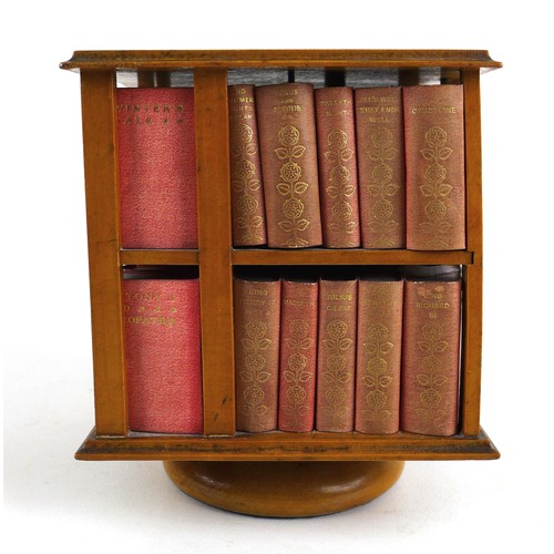 92 - A miniature table top revolving bookcase, containing a set of forty miniature Shakespeare plays, in ... 