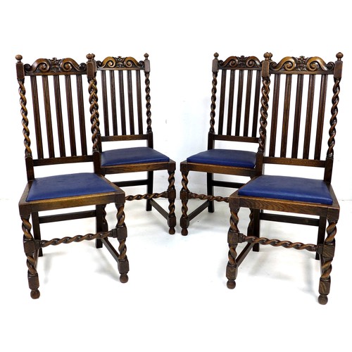 242 - A set of four Edwardian oak dining chairs, with carved crests to the rails, five splat back, and bar... 