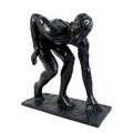 Ian Rank-Broadley FRBS (British, b. 1952): 'Crouching Youth', a bronze figural sculpture, with dark ... 