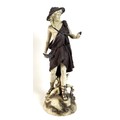 A Rudolstadt ivory porcelain figure modelled as a male dressed in a bear skin and carrying a bird, o... 