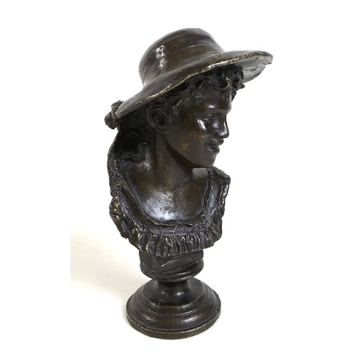 75 - A small bronze head and shoulders bronze bust of a youth wearing a hat, dark brown patina, 18.5cm hi... 