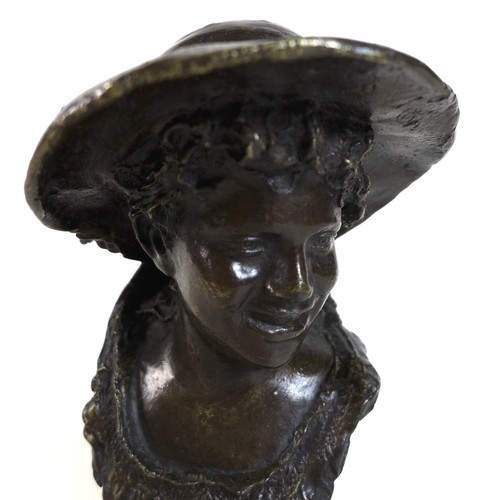 75 - A small bronze head and shoulders bronze bust of a youth wearing a hat, dark brown patina, 18.5cm hi... 