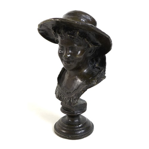 75 - A small bronze head and shoulders bronze bust of a youth wearing a hat, dark brown patina, 18.5cm hi... 