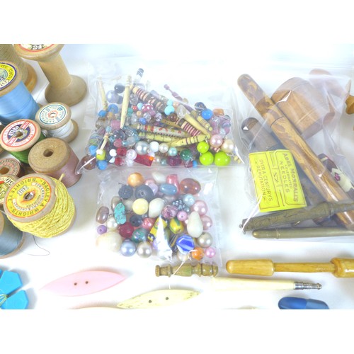 41 - A collection of sewing and needlework items, including several bobbins, crocheting tools, reels of c... 