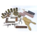 A collection of brass measuring tools including, brass weights, various measuring cups, two sliding ... 