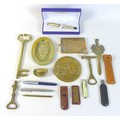 A group of brass items, including a couple of ash trays, three bottle openers, one shaped as a key, ... 
