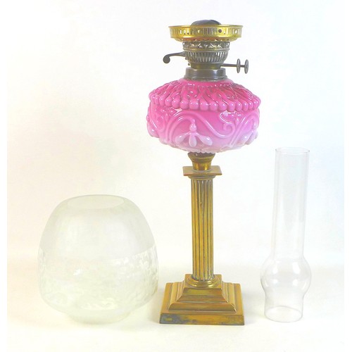 284 - A Victorian paraffin lamp, with pink moulded glass reservoir, brass reeded column, etched clear glas... 