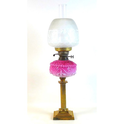 284 - A Victorian paraffin lamp, with pink moulded glass reservoir, brass reeded column, etched clear glas... 