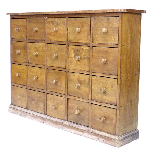 301 - An early to mid 20th century pine drawer unit, with an arrangement of twenty drawers, turned handles... 