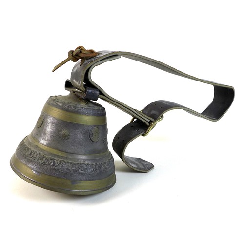 57 - A French cast metal cow bell, 'Puy Mary', 22.5 by 19cm high, with wide leather strap.