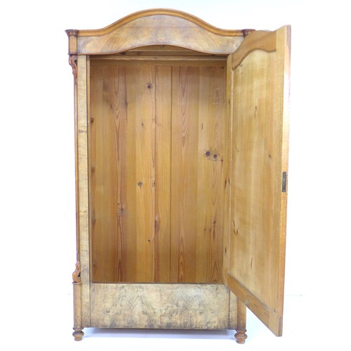 289 - A 19th century mahogany veneered wardrobe, single arched door enclosing a hanging space, raised on t... 