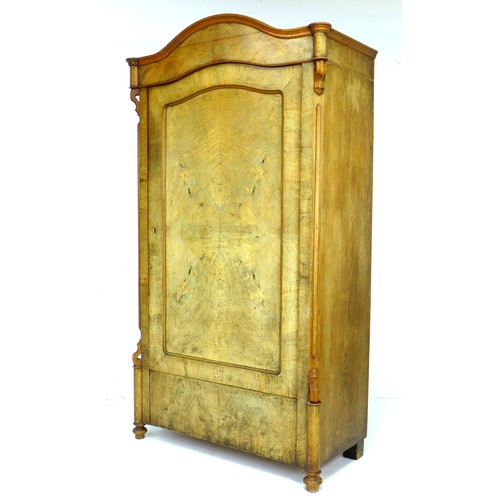 289 - A 19th century mahogany veneered wardrobe, single arched door enclosing a hanging space, raised on t... 