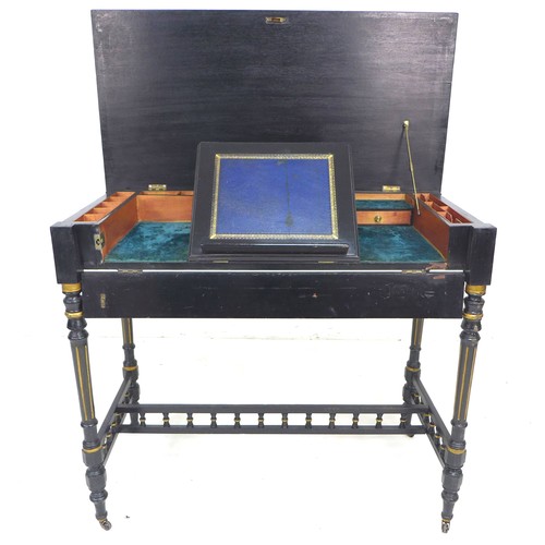 288 - A Victorian ebonised and gilt highlighted lady's writing desk, with lift top revealing a fitted inte... 