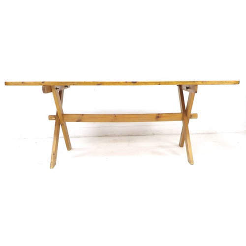 246 - A pine kitchen table, mid to late 20th century, with X frame trestle base, 90 by 183 by 76cm high.