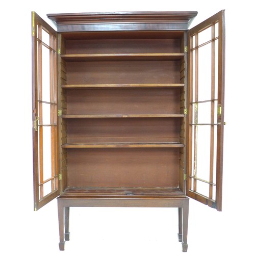 283 - An Edwardian mahogany display cabinet, twin astragal glazed doors enclosing four adjustable shelves,... 